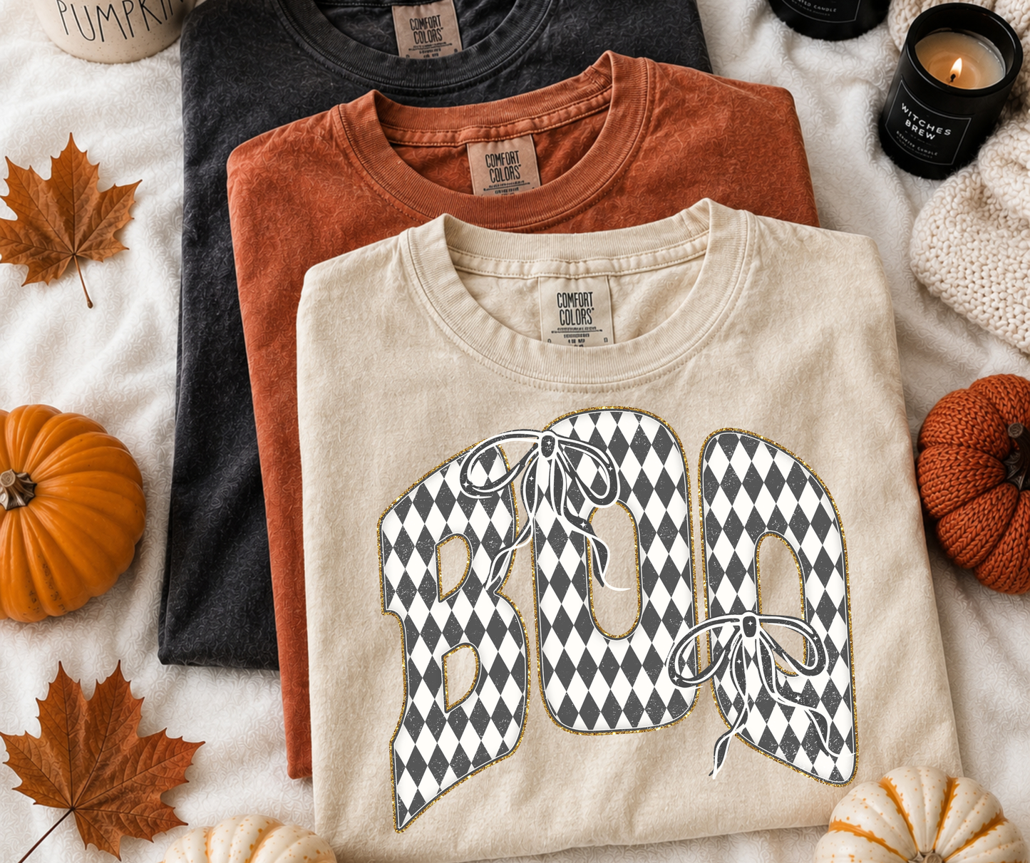 Checkered BOO Bow Graphic Tee on an Ivory Comfort Colors shirt featuring oversized black and white harlequin BOO lettering with bows