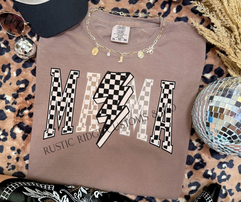Checkered Lightning Bolt Mama Graphic Tee on an Espresso Comfort Colors shirt featuring checkerboard MAMA lettering and lightning bolt