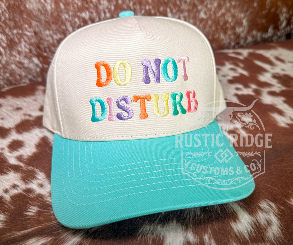 Do Not Disturb seafoam trucker hat with colorful embroidered lettering and seafoam bill by Rustic Ridge Customs & Co