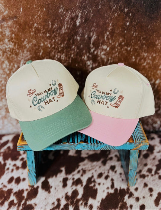 This Is My Cowboy Hat embroidered trucker hats in sage green and pink with western design by Rustic Ridge Customs & Co