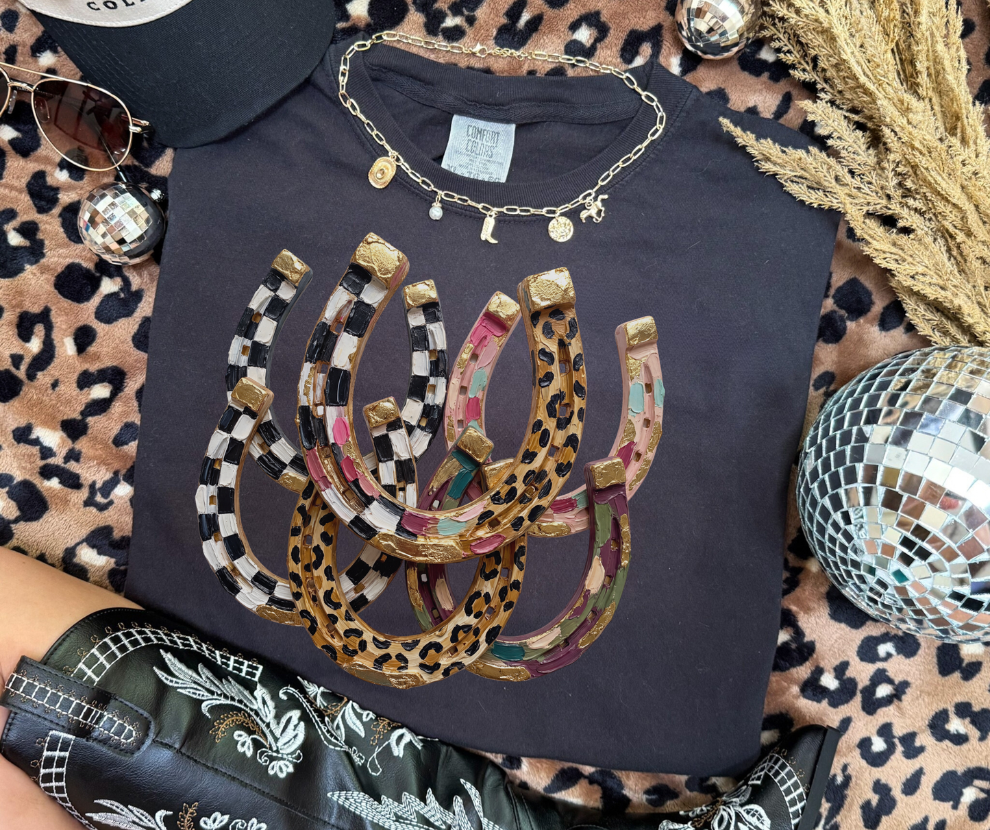 Lucky Charm Horseshoes Graphic Tee in black with colorful leopard and checkerboard western horseshoes