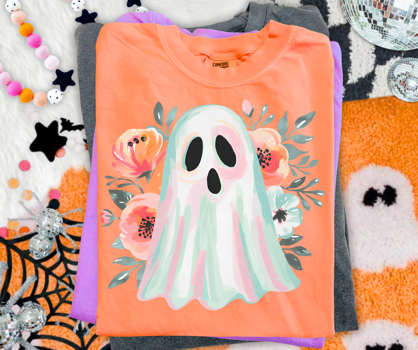Painted Floral Ghost Graphic Tee on a Neon Cantaloupe Comfort Colors shirt with a colorful watercolor ghost and flowers