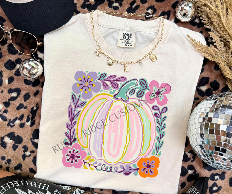 Pastel Pumpkin graphic tee in Ivory Comfort Colors with colorful floral pumpkin design