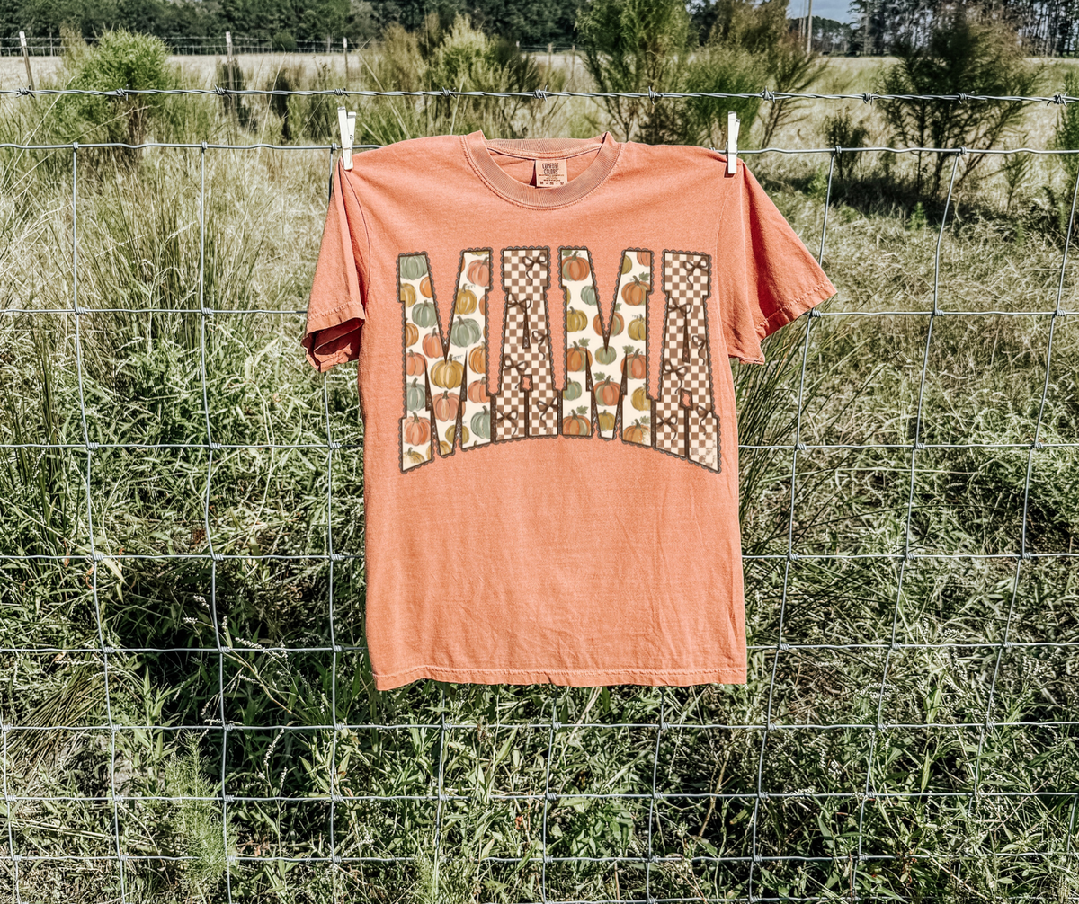 Pumpkin Fall Mama graphic tee in Terracotta Comfort Colors with pumpkin and checkerboard MAMA design