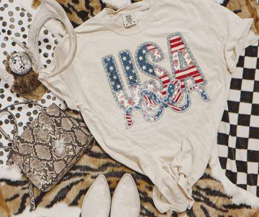 USA patriotic bow graphic tee with Americana patchwork lettering on Comfort Colors shirt by Rustic Ridge Customs & Co