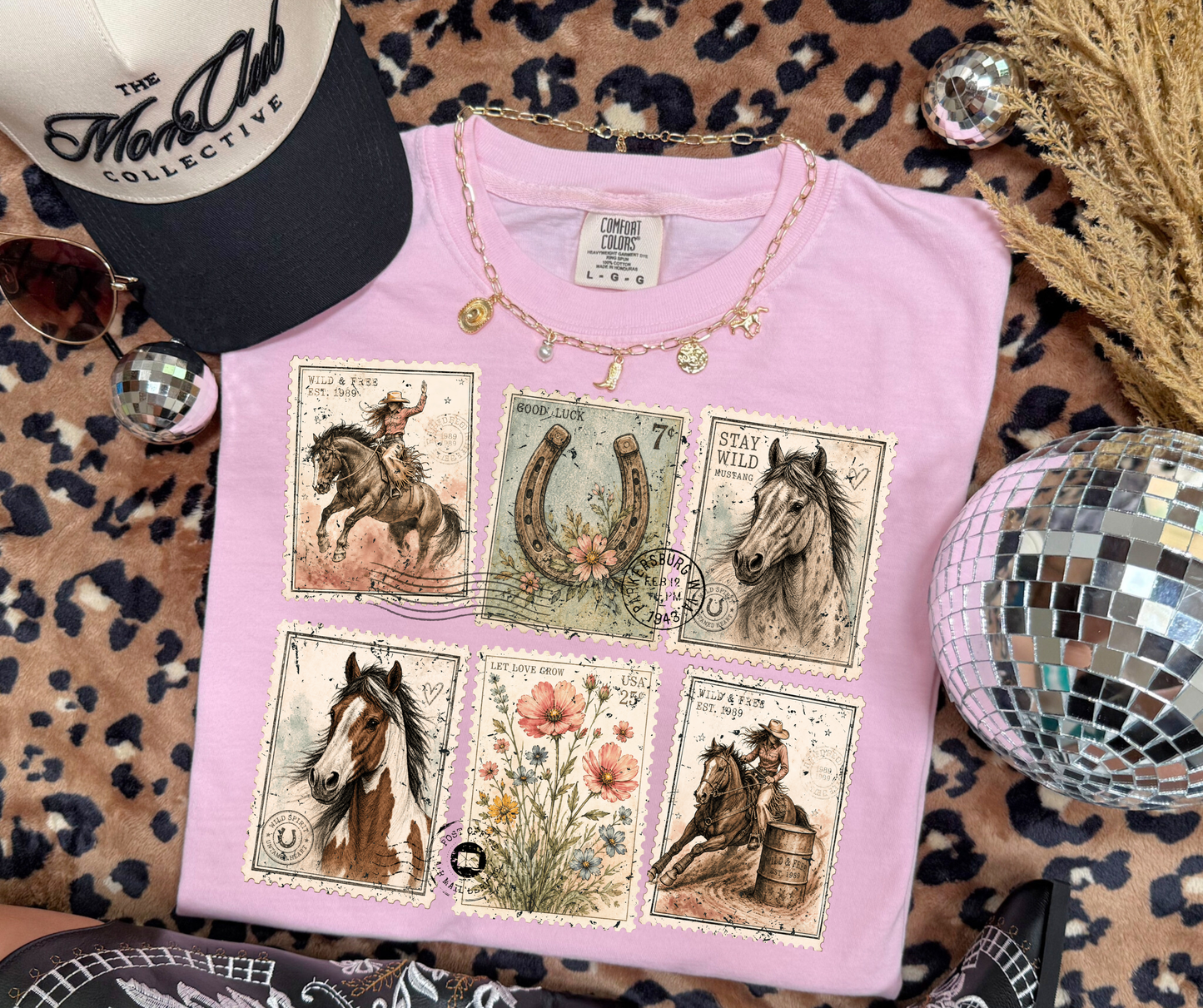 Wild and Free Western Postage graphic tee on Blossom Comfort Colors featuring horses, cowgirls, wildflowers and horseshoe artwork.