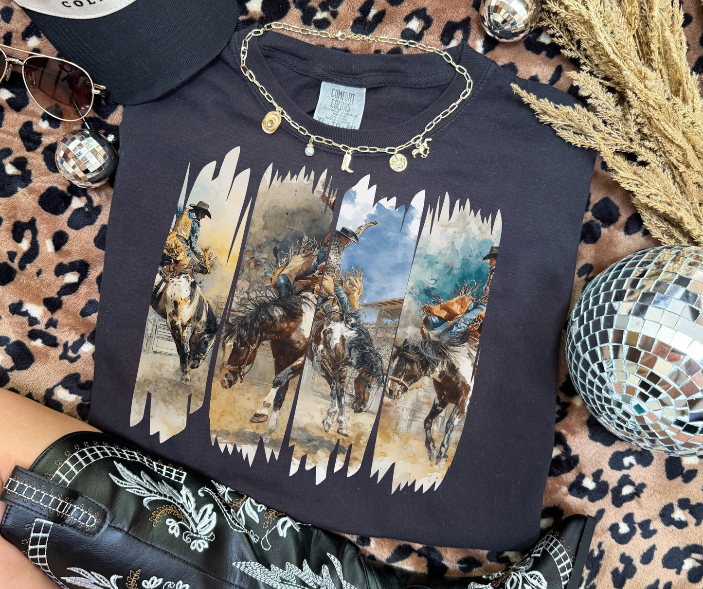 Wild Ride Rodeo Graphic Tee in black featuring watercolor bronc riders and western rodeo artwork