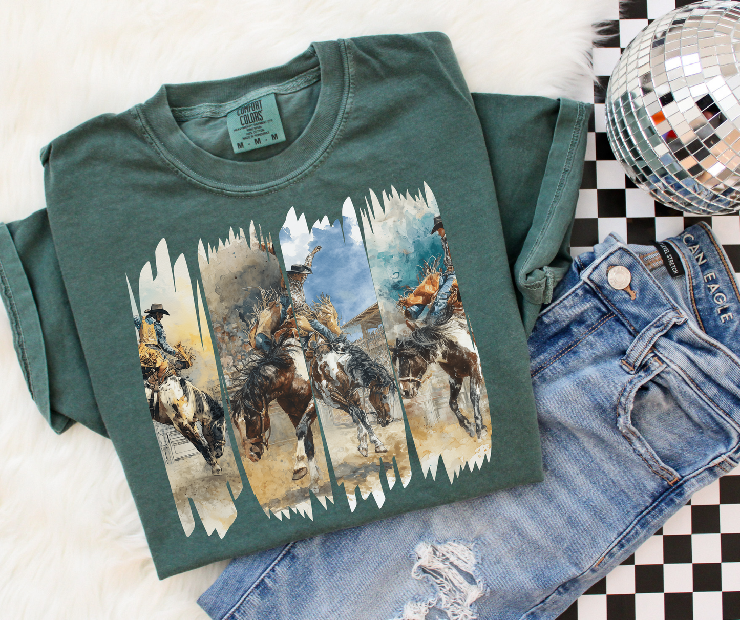 Wild Ride Rodeo Graphic Tee in Blue Spruce featuring watercolor bronc riders and western rodeo artwork